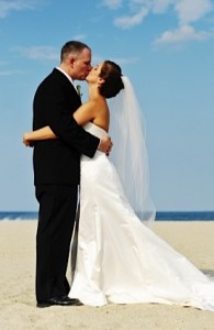 On beach wearing perfect wedding gown